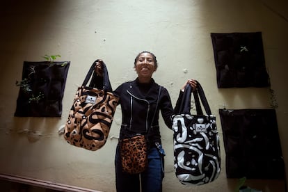 Vaneza San Martin poses with some of the bags that produces and sells in 'El Tambo Afro'.
