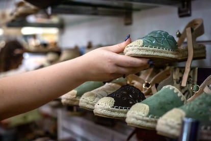 A woman contemplating the exposed shoes.