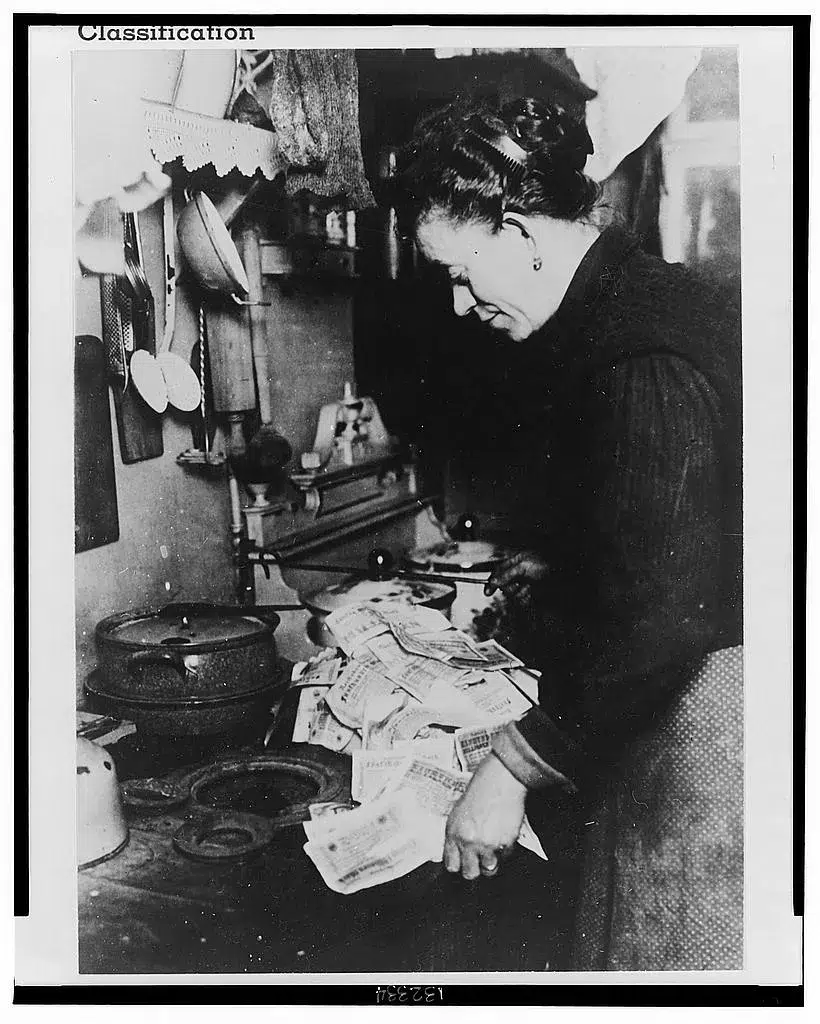 German woman destroys dozens of devalued banknotes.