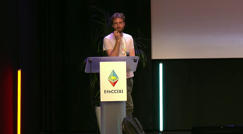 Justin Drake on stage giving a lecture.
