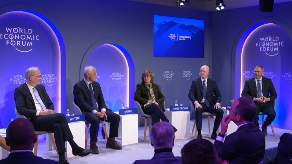 Photograph of the panelists at the World Economic Forum in Davos.